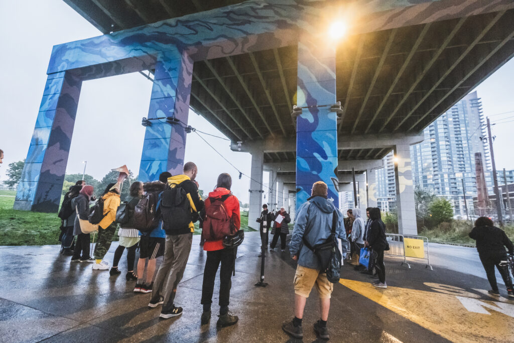 Group of workshop participants standing under the Gardiner