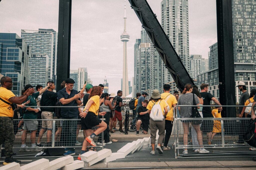 Members of the public run to follow a trail of life-sized dominoes through the city of Toronto.