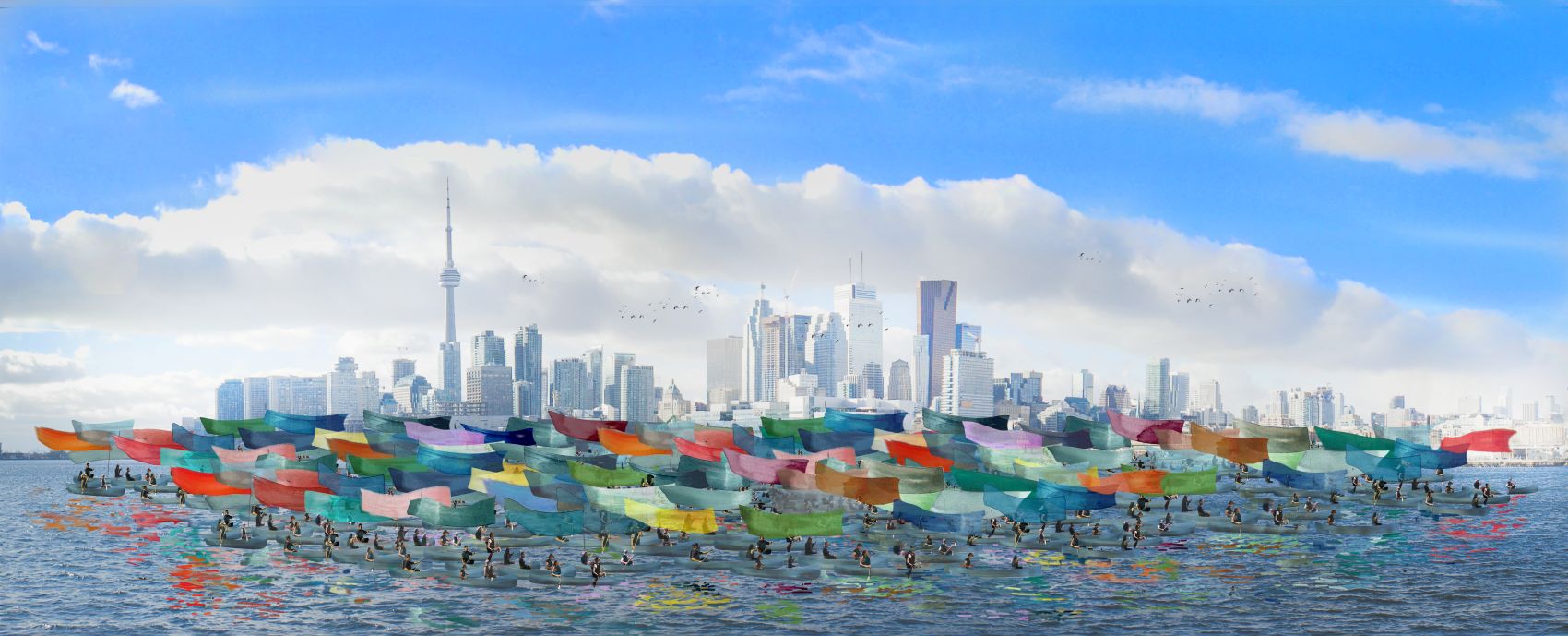 A fleet of 100 canoes carrying colourful silk paintings soars along Lake Ontario in front of the Toronto skyline