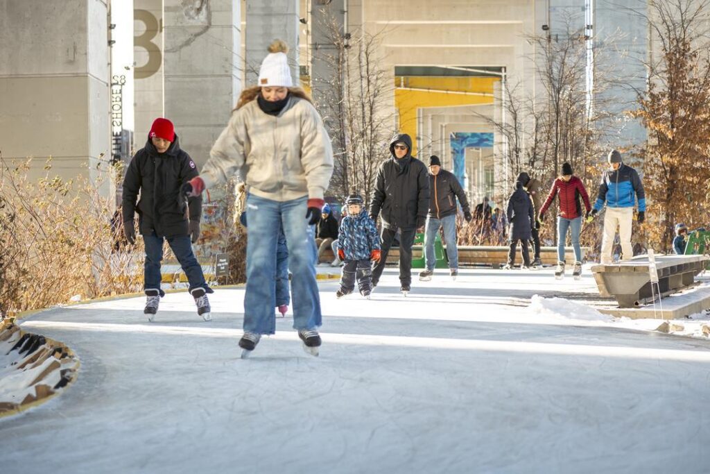 Front view of people enjoying The Bentway skating rink.