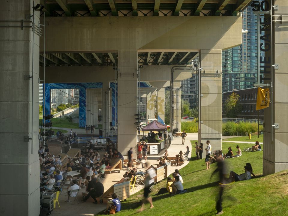 People gathered under the Gardiner Expressway enjoying The Bentway site.
