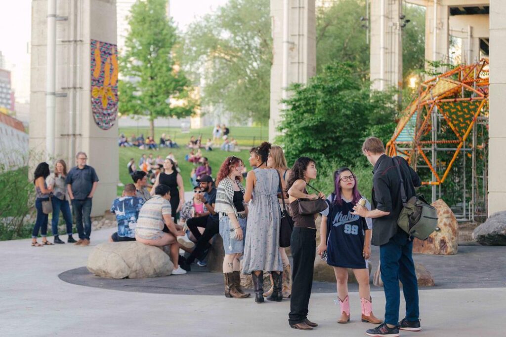 A group of people gathered on the Bentway Skate Trail for the Softer City Opening Night Party